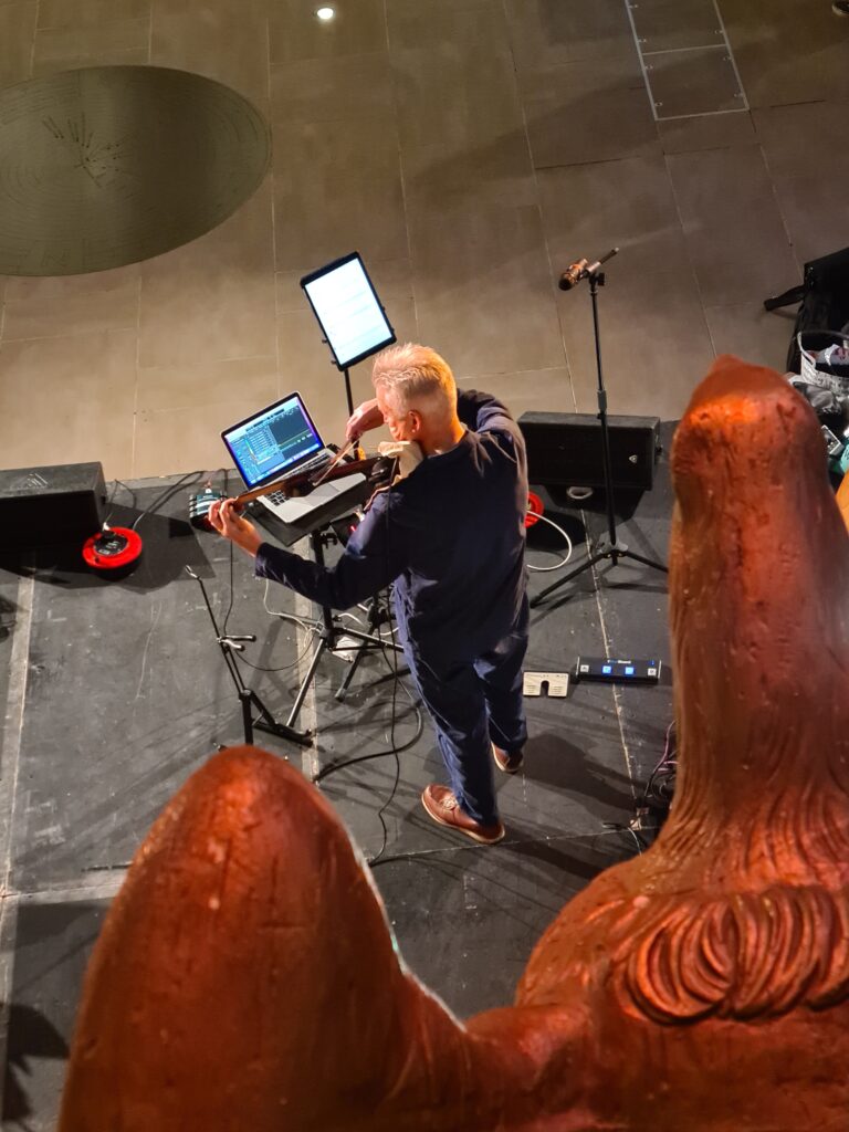 Musician Nic Pendlebury playing the electric viola at the Cutty Sark Soundscape launch event.