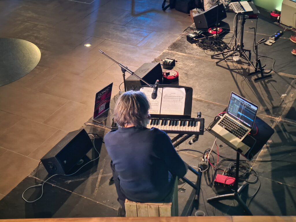 Musician Colin Riley playing the keyboard at the Cutty Sark Soundscape launch event.